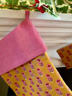 Pink and yellow patterned fabric with a white window pane in the background