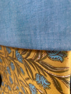 Close-up of blue fabric and gold floral-patterned fabric