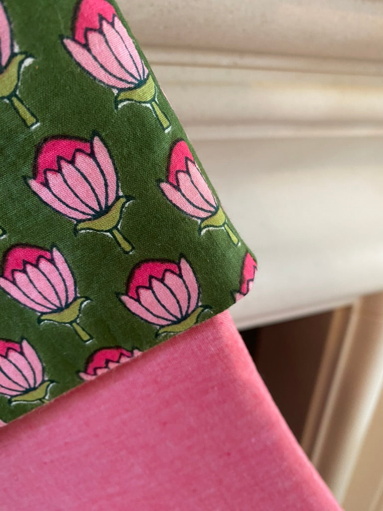 Close-up of a green fabric with pink floral christmas stocking