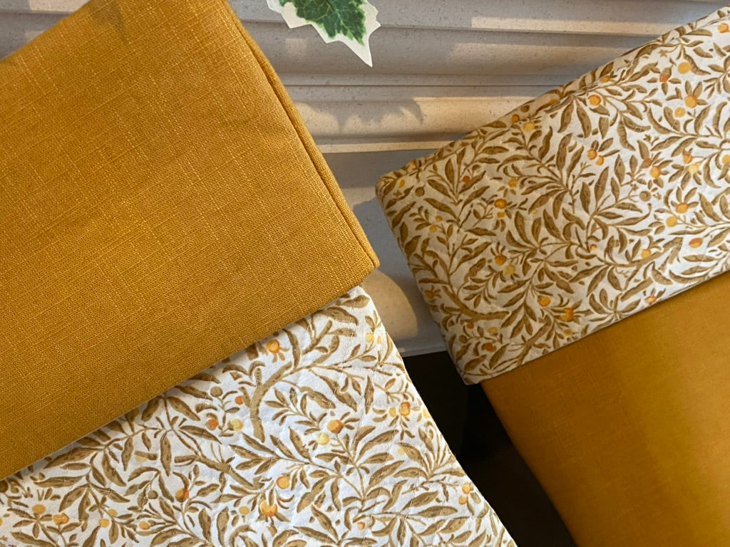 linen quilted christmas stockings hanging on fireplace