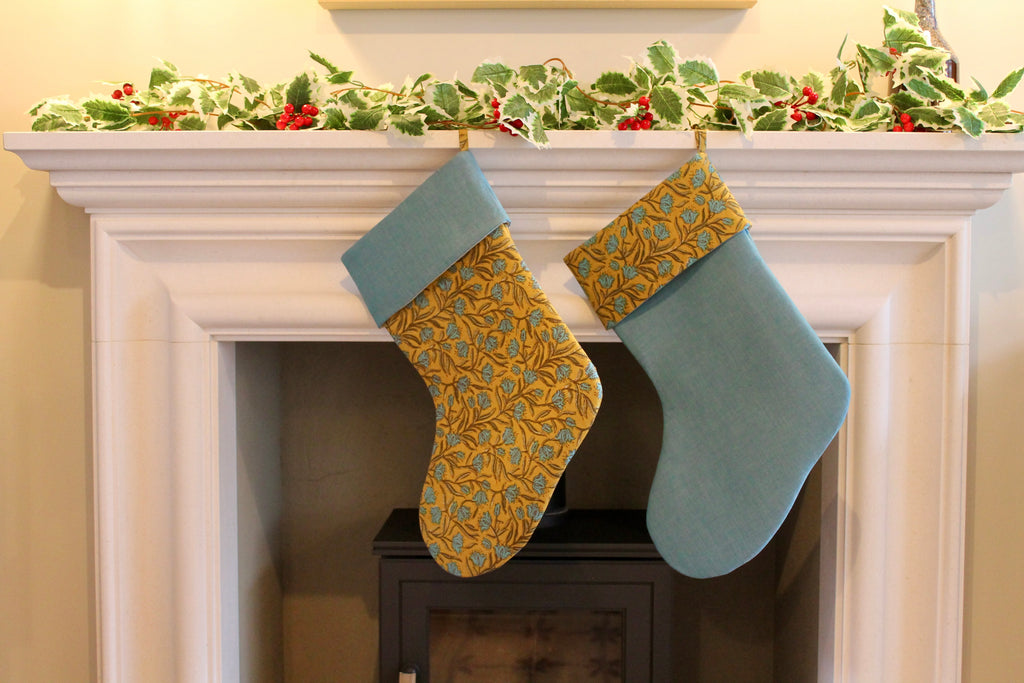 two christmas stockings hanging from fireplace