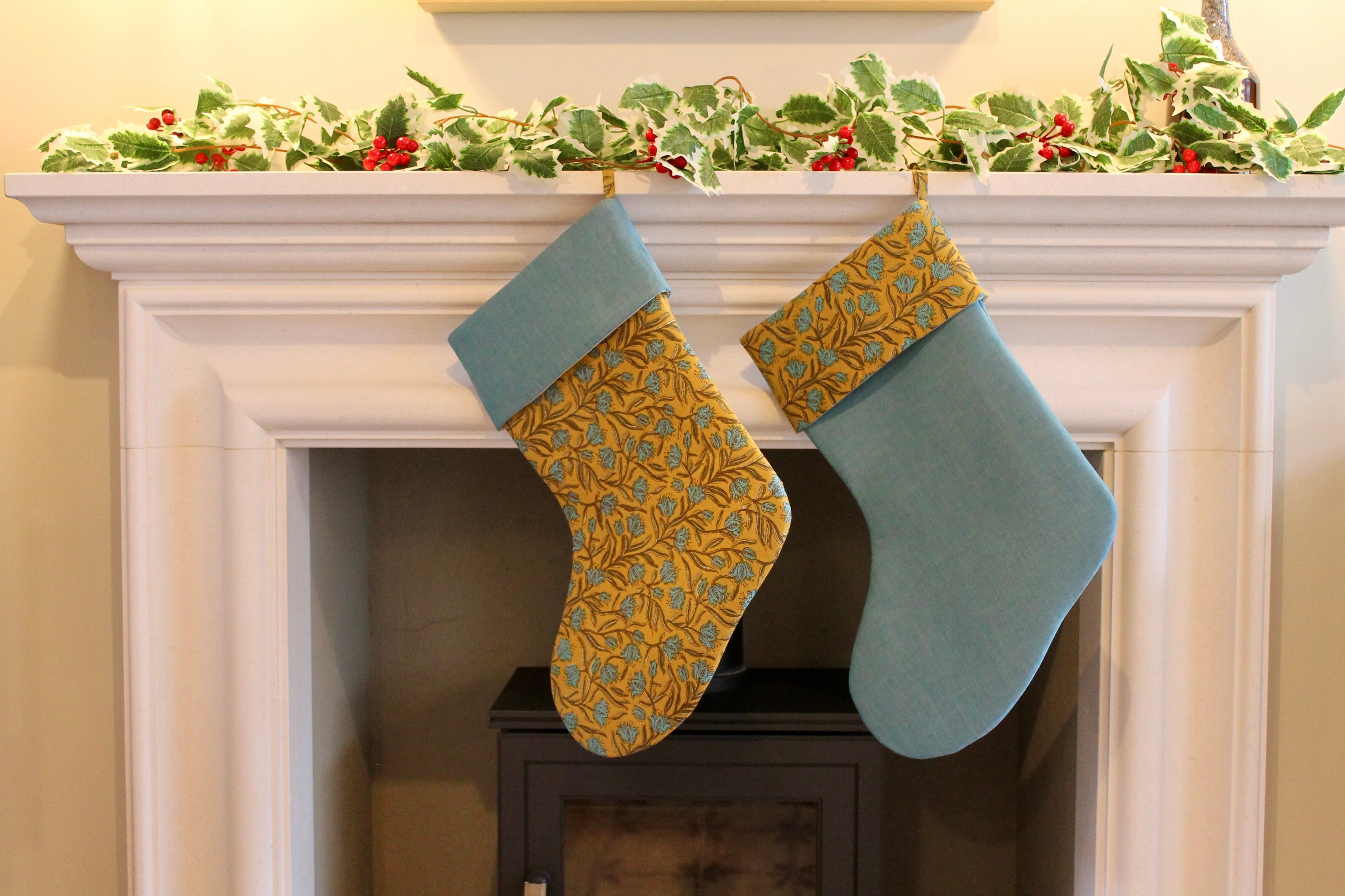 two christmas stockings hanging from fireplace