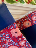 red and navy floral indian block print patterned christmas stockings hanging from fireplace