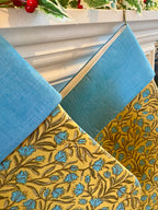 Two blue and yellow christmas stockings 