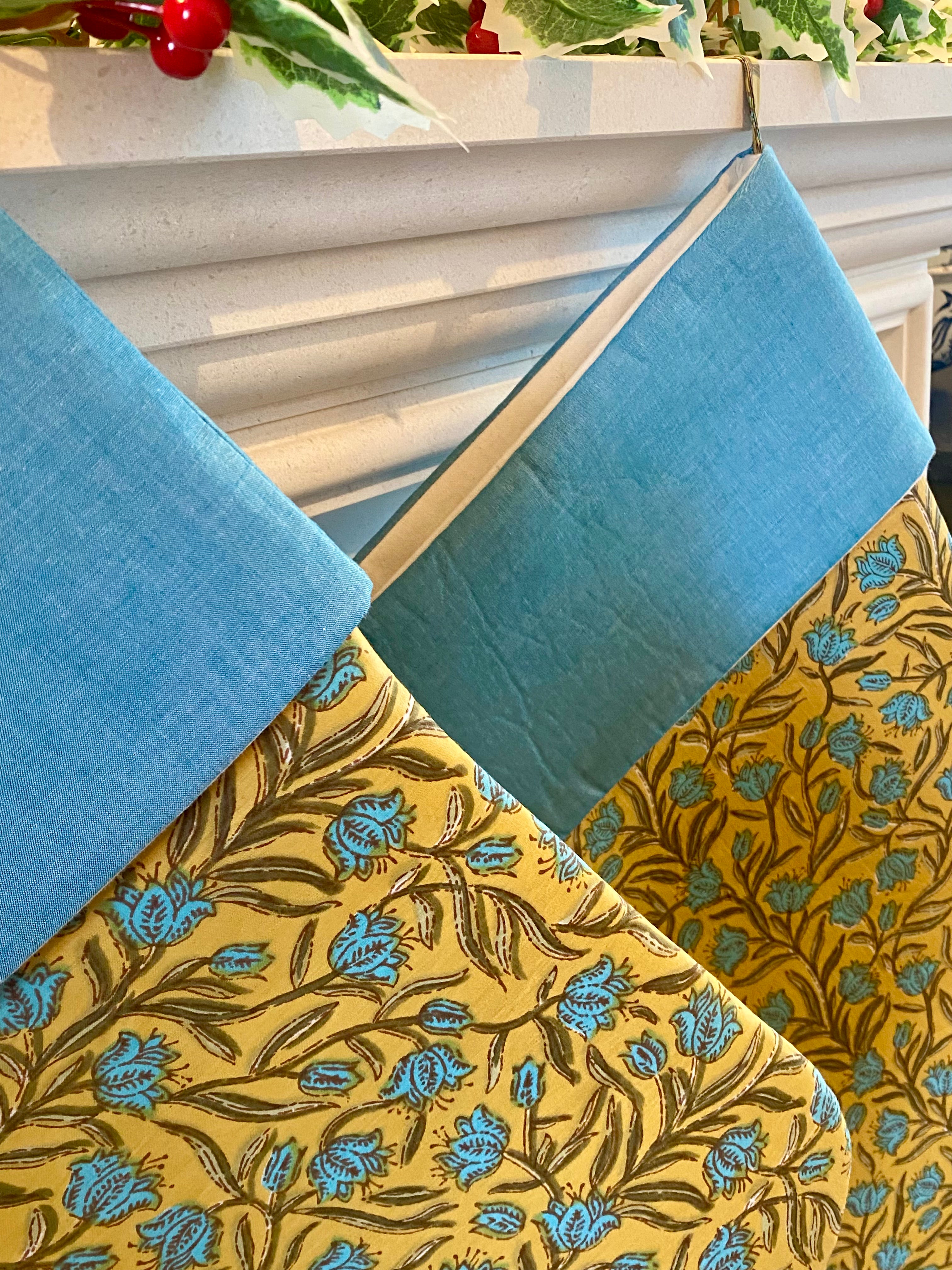 Two blue and yellow christmas stockings 